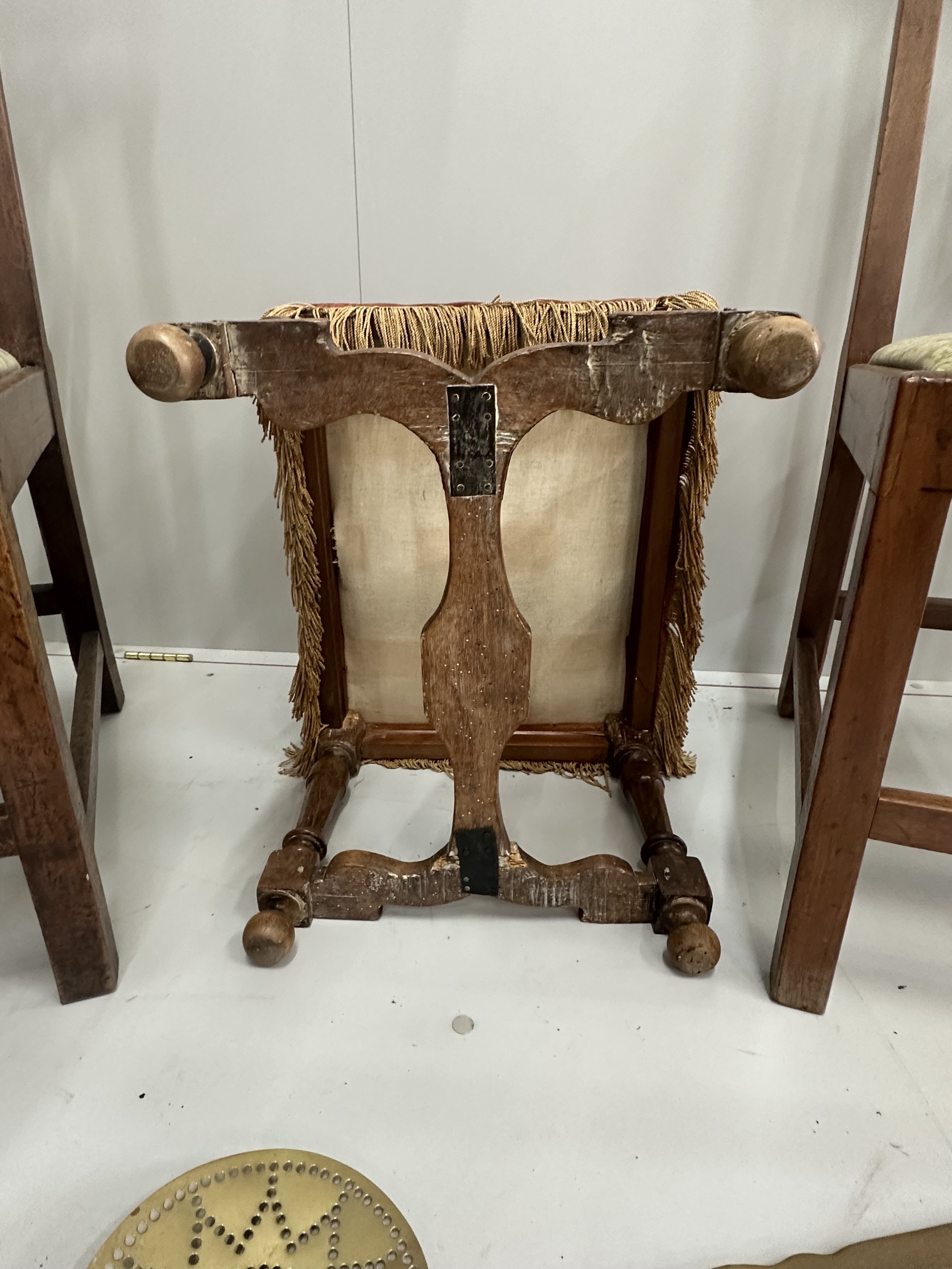 A pair of Chippendale style walnut dining chairs with drop in seats, an 18th century style walnut footstool and a pair of Victorian brass chestnut roasters